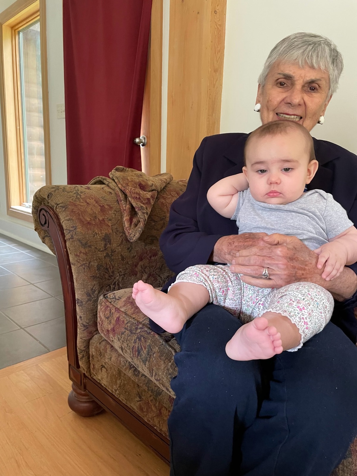 Toby holding her first great-granddaughter, Maya.